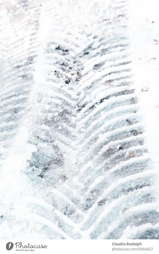 Close-up of tire tracks in frozen snow Wintry road conditions winter road Skid marks ice and snow Ice and frost Winter Black ice Frost Snow Weather Winter mood