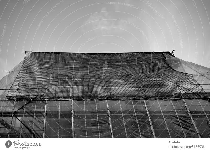 Wrapped house on a construction site b/w Construction site House (Residential Structure) Scaffold Tarp construction net construction foil Net Renovation