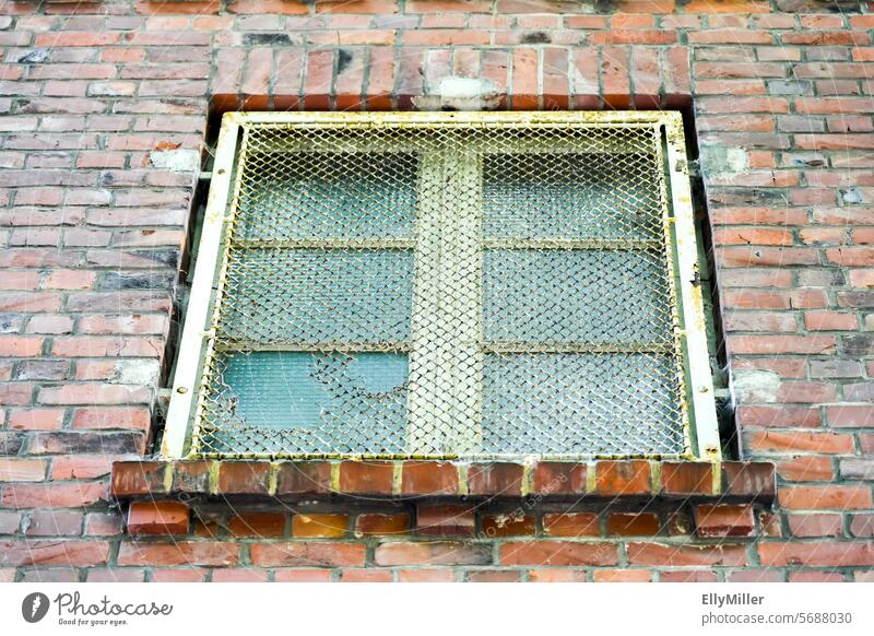 Old barred window on the abandoned industrial building Window Industry Grating latticed Facade Building Wall (building) House (Residential Structure)