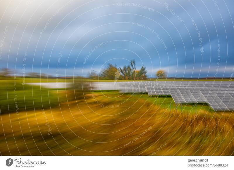 Passing a landscape with forest in early fall with photovoltaic system, blurred and zoomed. drive past hazy Movement motion blur Meadow Forest trees Nature