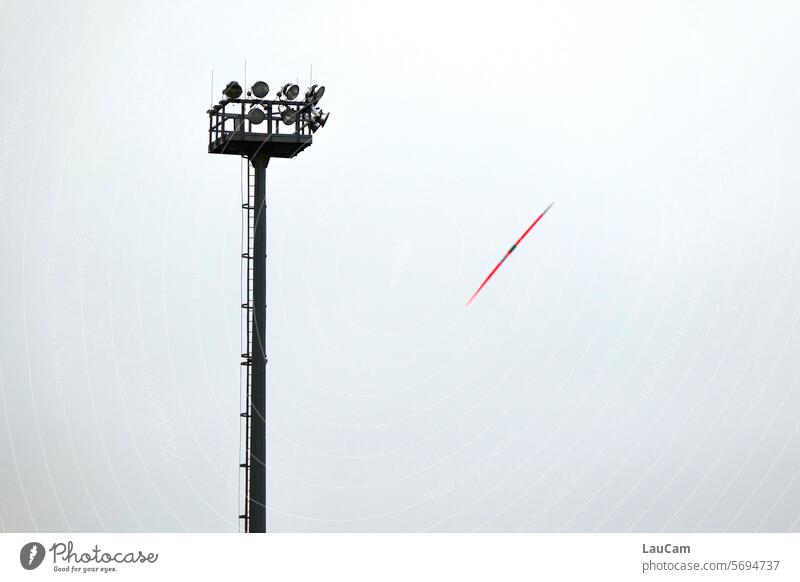Javelin throwing - flying object in the spotlight javelin Javelin (sporting event) Flying Floating in flight Track and Field Floodlight competition Stadium Lamp