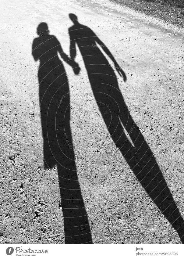 Two people cast two silhouettes as shadows on the floor Love love Couple hold hands holding hands Silhouette Shadow shadow cast Shadow image Shadow play Lovers