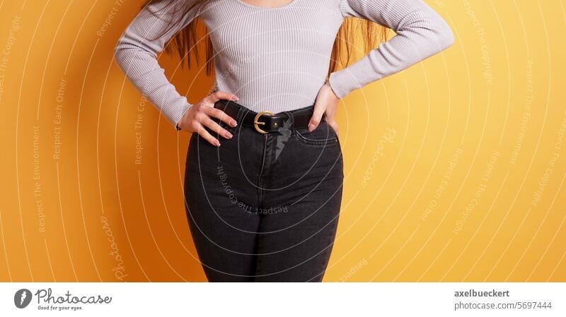 https://www.photocase.com/photos/5697444-curvy-young-woman-with-womanly-figure-or-curves-wearing-tight-black-jeans-photocase-stock-photo-large.jpeg