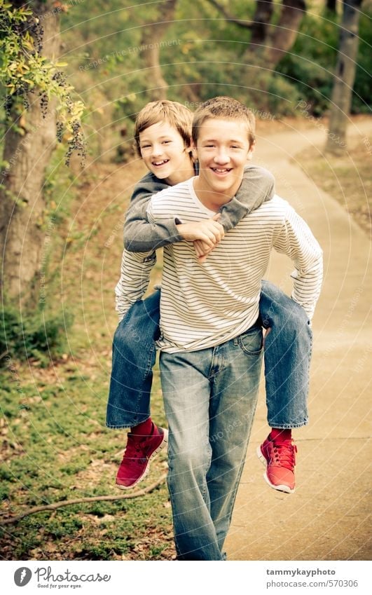 Older brother giving piggyback to younger brother. Beautiful Young man Youth (Young adults) Brother Family & Relations Friendship 2 Human being 8 - 13 years