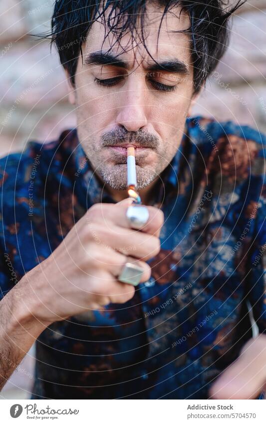 Man lighting a cigarette with a lighter man smoking close-up focus match smoke habit addiction nicotine tobacco adult male portrait casual outdoor serious