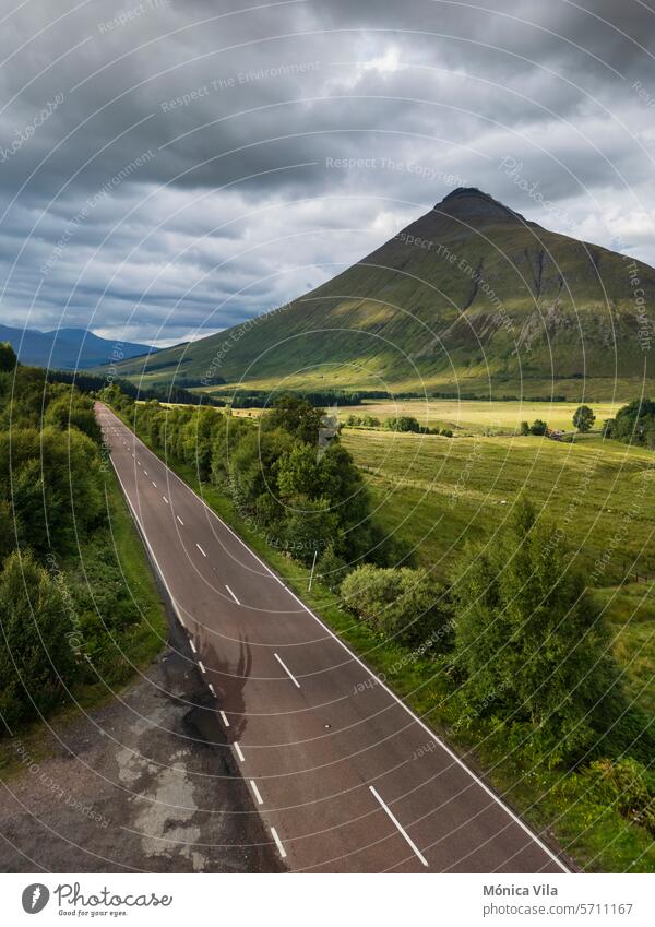 The A82 road passing through Bridge of Orchy in the Scottish highlands. Scotland England mountains green grass nature forest conifers cloudy sky Landscape Hill