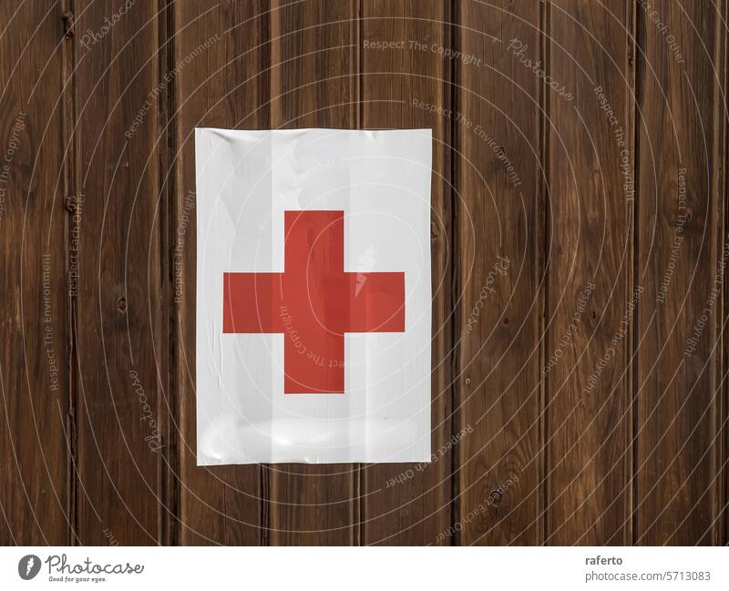 the red cross on a white background, affixed to a wooden surface beach symbol medical aid emergency health safety assistance first-aid doctor hospital clinic