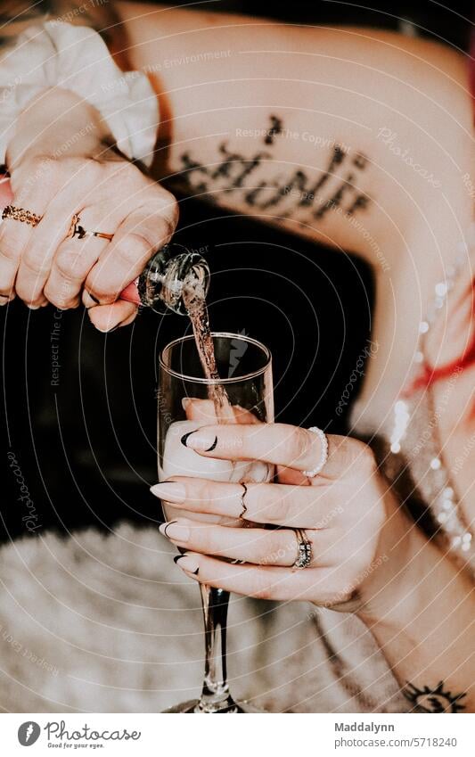 A woman pouring a glass of Champagne into a glass Party Champagne bottle Champagne glass Alcoholic drinks Sparkling wine Glass Prosecco Beverage