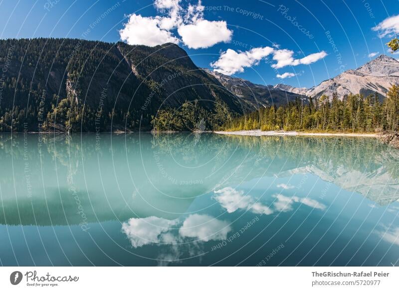 Sky and mountains are reflected in the turquoise lake mirror Lake kinney lake Vantage point Water Colour photo reflection mountain panorama Mountain Nature