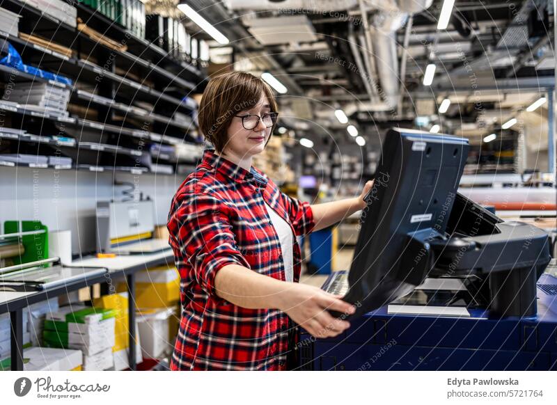 Woman working in a printing factory business employee female industrial industry job logistics manufacture manufacturing occupation people product production
