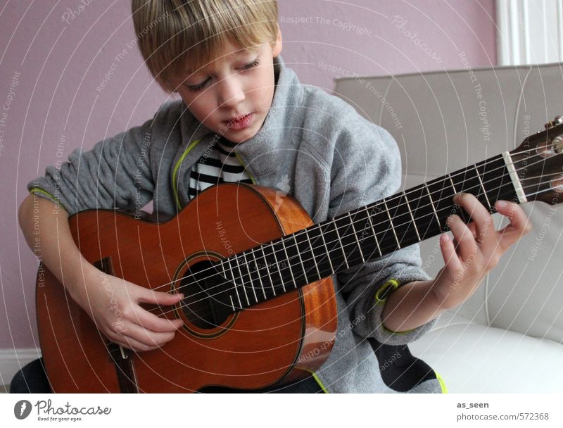 The boy with the guitar Masculine Boy (child) 1 Human being 3 - 8 years Child Infancy Music Musician Guitar Blonde Wood Touch Listening Make Authentic Brown