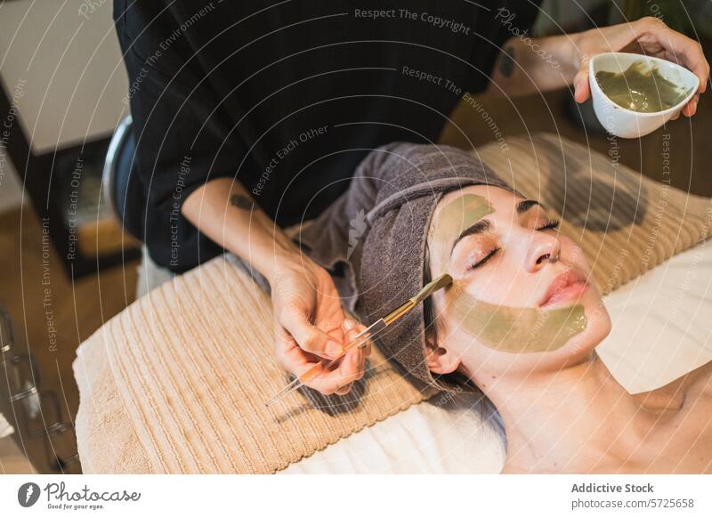 Woman receiving a facial treatment at a spa woman beautician mask skincare relaxation therapy wellness beauty aesthetic pampering rejuvenation tranquil serene