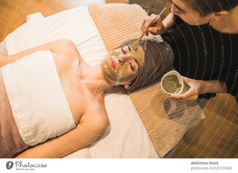 Relaxing facial treatment at a spa with a clay mask beautician relaxation skincare beauty health wellness luxury service pampering serenity calm towel person