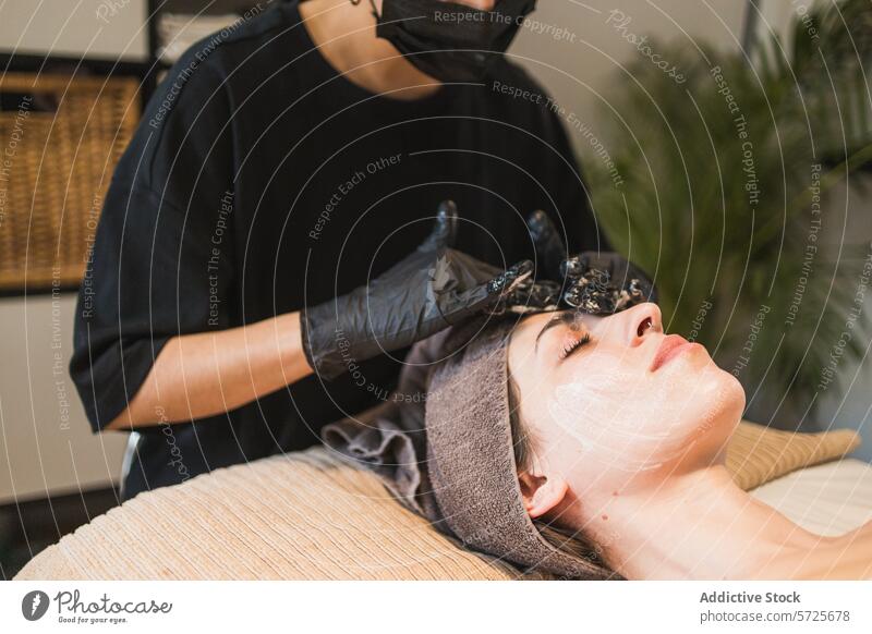 Woman enjoying a facial treatment at a spa woman skincare mask aesthetician gloves beauty relaxation wellness health pamper hygiene professional client service