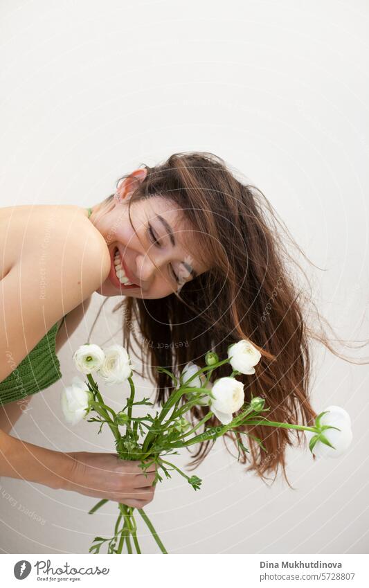 beautiful woman in green crochet handmade top with white flowers smiling on white wall minimal background Woman youthful Spring Green Crochet Top handcrafted