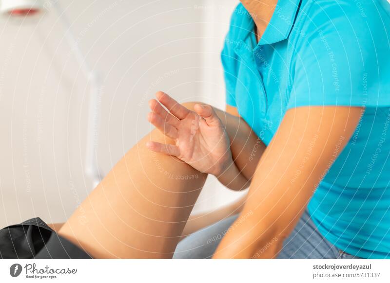 A physical therapist manipulates the patient's knee and leg area to release muscle tension and pain physiotherapist clinic rehabilitation health care
