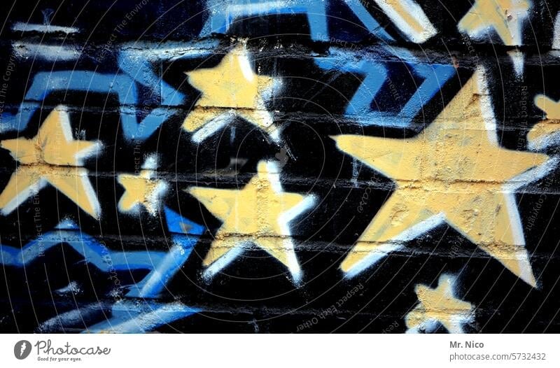 Star I sign stars Graffiti Yellow Blue Wall (barrier) Wall (building) Art Creativity Mural painting Starry sky Star (Symbol) Facade Youth culture Daub Trashy *