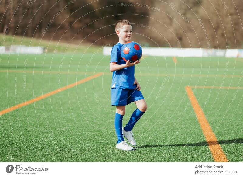 Young soccer player kicking ball on field - a Royalty Free Stock Photo ...