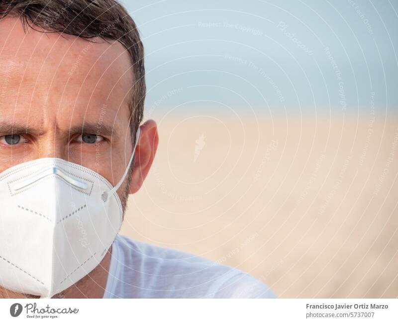 Solitary Figure with Protective Mask in a Vast Landscape face mask figure blurred landscape open sky clear vast solitude outdoors nature white shirt serene