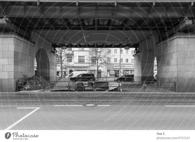 Homeless under the elevated train Prenzlauer Berg b/w Tramp Winter Schönhauser Allee Capital city Downtown Old town Town Berlin Exterior shot Deserted