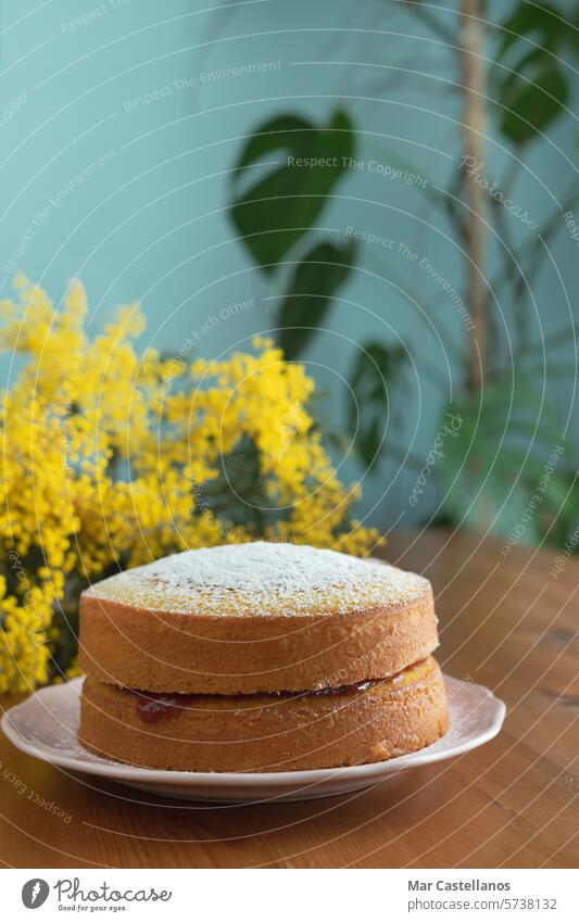 Maria Luisa cake filled with jam on a wooden table with a background of yellow flowers. Pie biscuits Dessert Food Cake Self-made cute Delicious Bakery Tasty