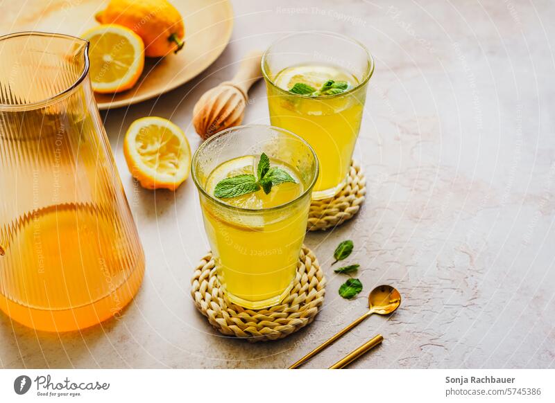 Homemade lemonade in two glasses. Refreshing drink. Lemonade Cold drink Yellow Glass Beverage Summer Fresh Drinking water Studio shot Healthy Eating Vitamin