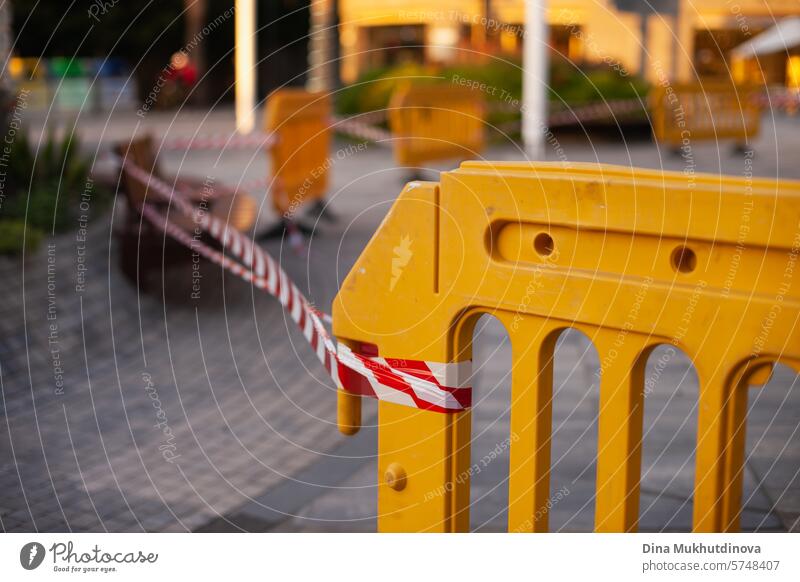 warning tape white and red striped in the street during urban construction maintenance works. Protection caution ribbon. Warning sign protection caution tape