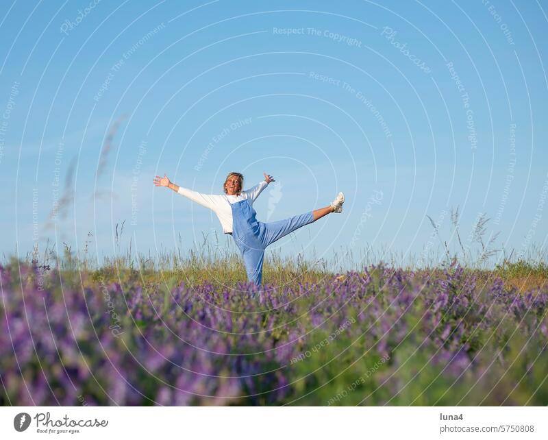 cheerful young woman in a meadow of flowers Woman Laughter jubilate Young woman Brash high-spirited outstretched arms Meadow fortunate emancipated pretty Hop