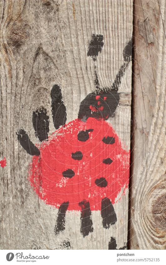 a drawn ladybug on a wooden hut. Drawing Wood Hut Cute Ladybird Embellish painting Children's drawing Creativity Leisure and hobbies