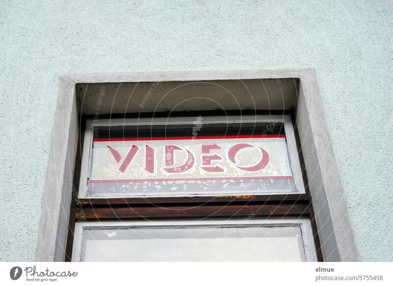 Blue house facade with window and the word VIDEO behind the glass pane Video Nostalgia video store videre Video rental Window Retro Past Video clip