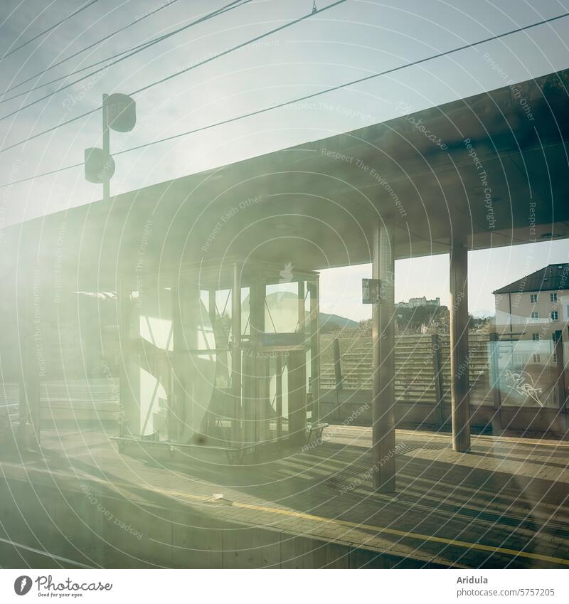 By train past the station with backlighting Track Train station Sun Back-light Local traffic Long distance traffic travel Window Train travel Platform