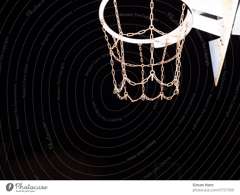 Stable basketball hoop in front of a black night sky Basketball basket Night Black darkness Contrast stable outline Silhouette Night sky Dark chains