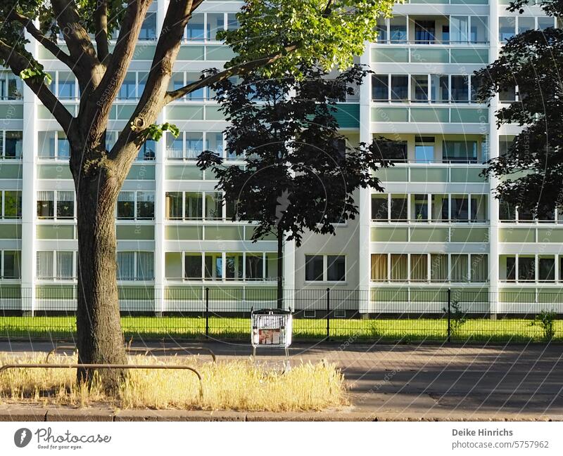 Empty shopping cart parked in front of an East Berlin 70s housing estate. Prefab construction Development area Frankfurter Allee South Architecture of the 70s