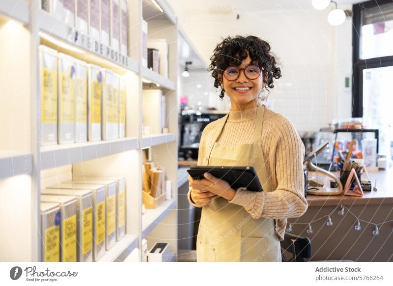 Small business owner using tablet in boutique shop small business woman browsing digital technology entrepreneur retail store cheerful businesswoman apron