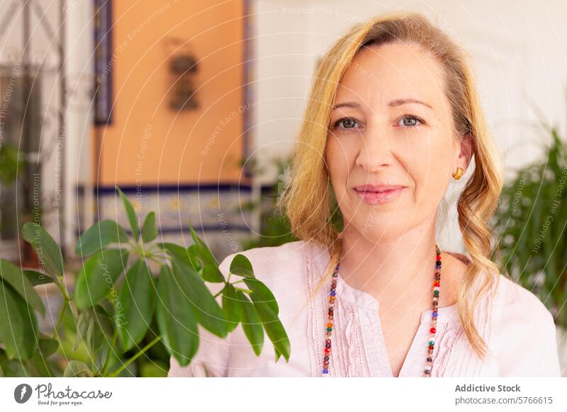 Confident woman with a serene smile in a Spanish courtyard portrait confident mature gentle warm contentment tranquil setting spanish pose mature adult