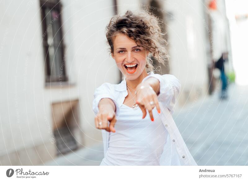 young girl walking on the old streets of europe hairstyle brown empty alone stone walls fashionable joy counting emotions glasses bright day clothes jeans