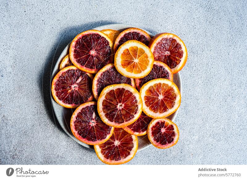 Freshly sliced Sicilian blood oranges on a plate sicilian fruit fresh vibrant juicy segment rich color contrast circular arrangement citrus mediterranean italy