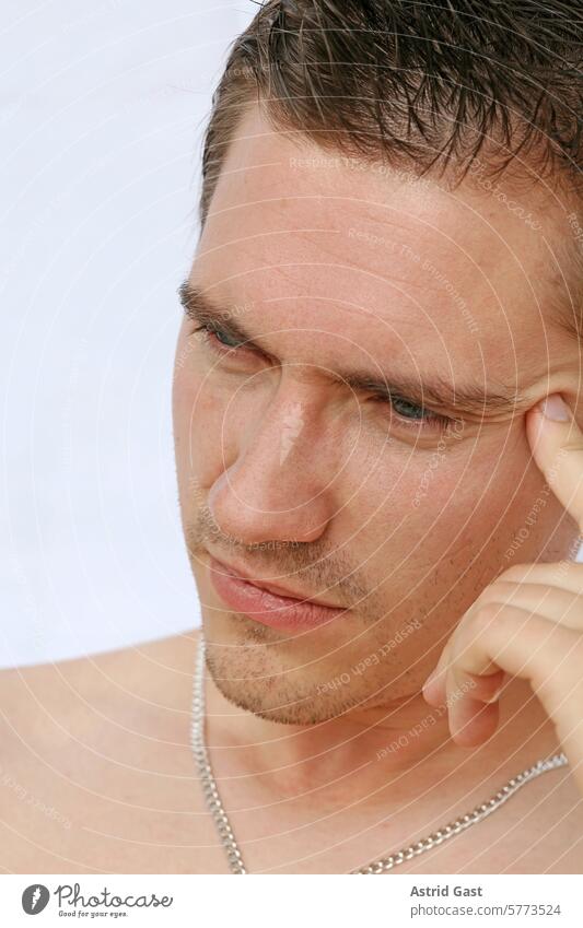 The face of a thoughtful young man Man Face Meditative ponder Head Fingers Headache headaches Expression gesture emotion Emotions youthful Young man Chain