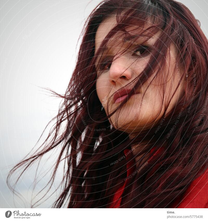 Woman in wind Long-haired Red-haired Dress feminine Downward Looking temporising Sky Wind blown hair windy wisps Feminine Skeptical Hesitate critical Observe