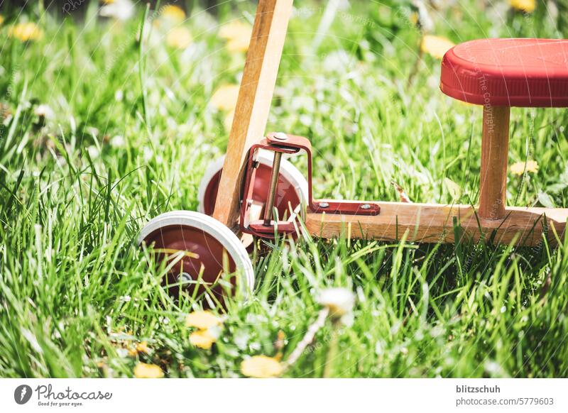 An old wheel in detail impeller Child Bicycle Infancy Toddler Playing Cycling Movement Leisure and hobbies Old Wheel Toys Close-up Detailed recording Mobility