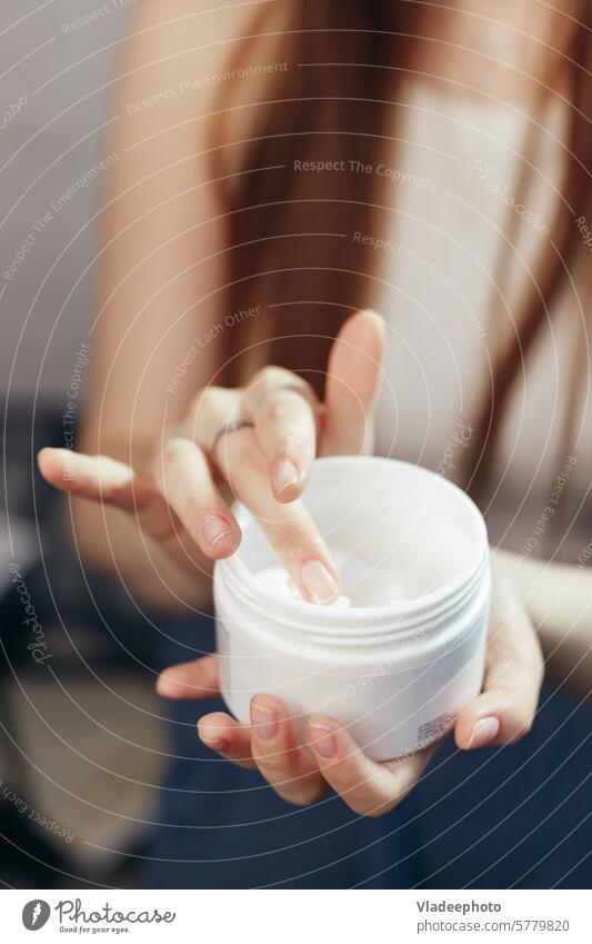 Close up view of crop female hands taking moisturizing cream from jar holding take close up woman skin care white finger touch cosmetics nourishing facial