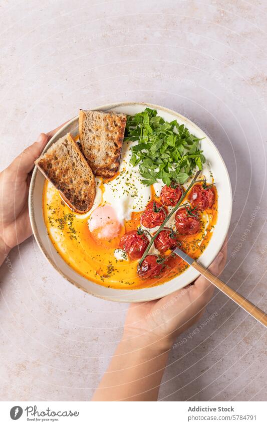 Turkish Eggs Dish With Spiced Butter and Yogurt turkish eggs greek yogurt garlic pepper salt olive oil ginger cherry tomatoes parsley bowl sauce butter