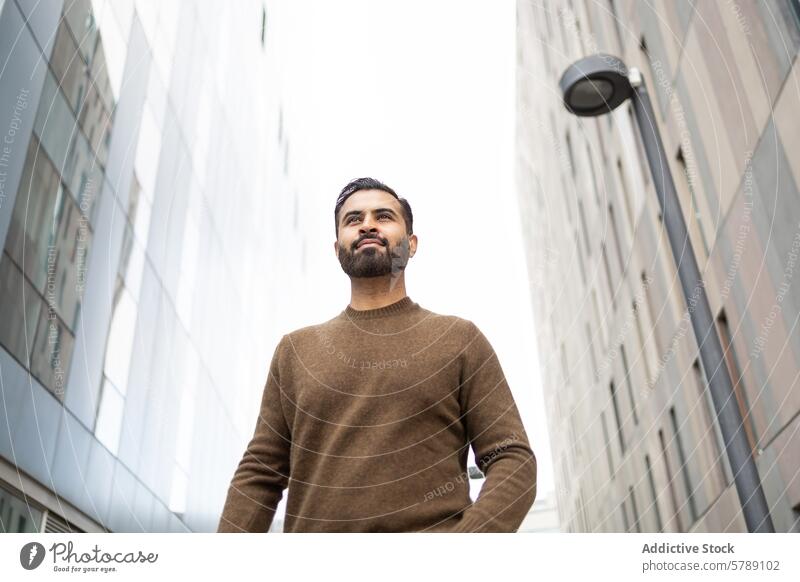 Confident urban man posing with modern architecture confidence outdoor sweater casual building sky daylight male city adult fashion style trendy lifestyle