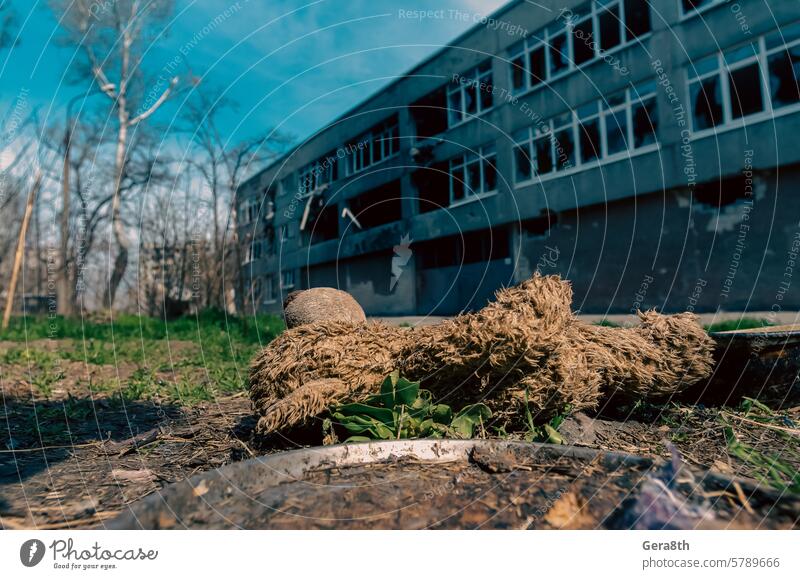 dirty toys on the background of a burned-out destroyed school in an abandoned city in Ukraine Donetsk Kherson Kyiv Lugansk Mariupol Russia Zaporozhye attack