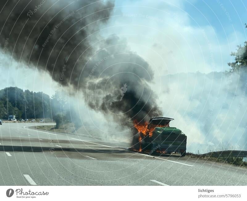 Burnt out - black cloud of smoke from a burning car on the side of the road burnout Accident Doom