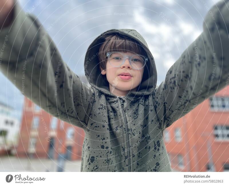 Boy in the city Child Infancy Boy (child) Looking into the camera Face portrait Close-up Exterior shot Authentic Upper body blurriness Front view Future