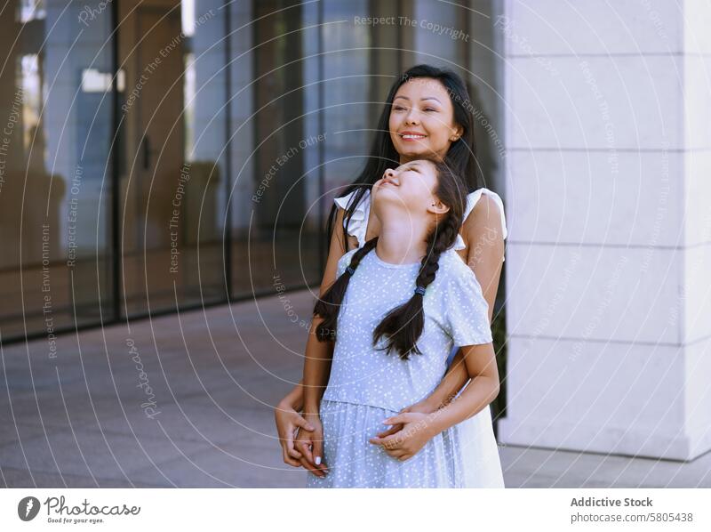 Girl with autism spectrum having fun with her mother while walking in the city Woman female daughter child person with autism ADHD neurodiversity childhood kid