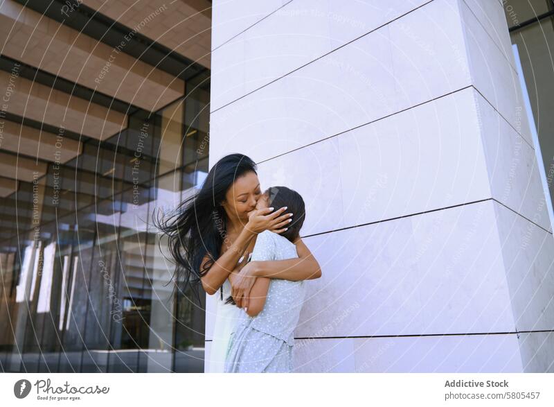 Girl with autism spectrum hugging her mother while walking in the city Woman female daughter child person with autism ADHD neurodiversity childhood kid