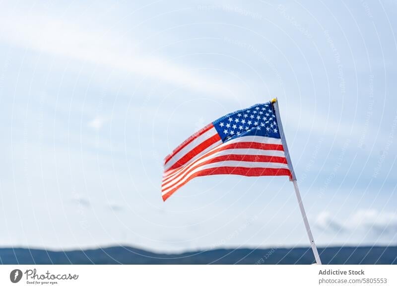 American flag waving against a clear blue sky american independence day usa symbol patriotism national freedom celebration july 4th stars and stripes banner