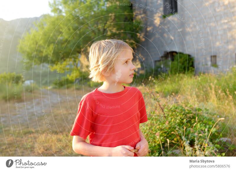 Preteen boy visiting of Fort Kosmach in Montenegro. Fortress is located near Budva. Old castle was built in Austro-Hungarian Empire as defensive structure and observation post.